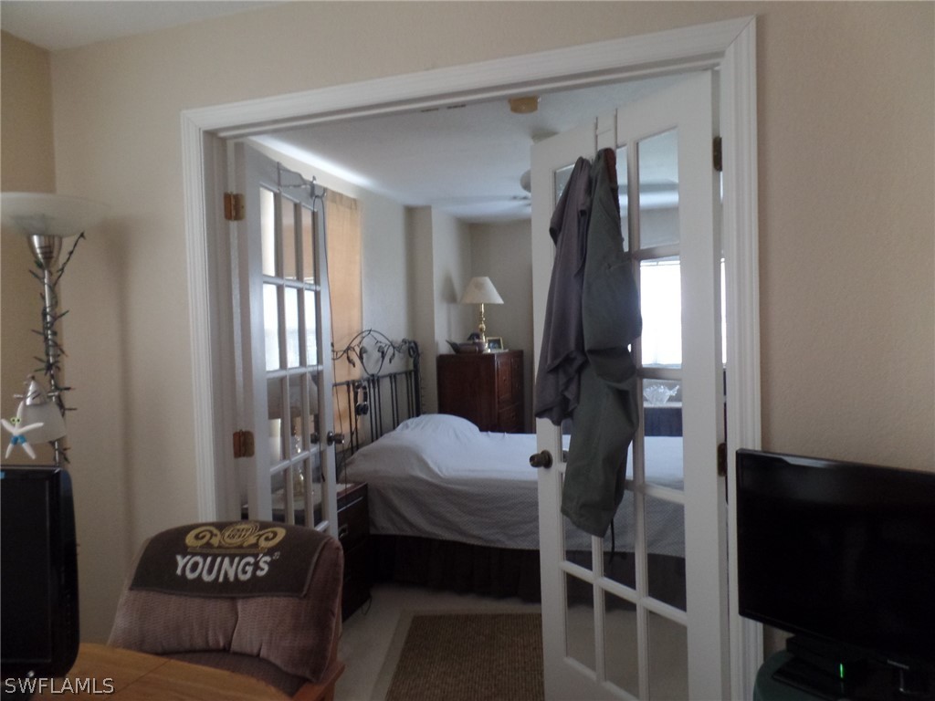 18275 Useppa Road Fort Myers, FL 33967 - Photo 8 of 8 a bedroom with a bed and a mirror