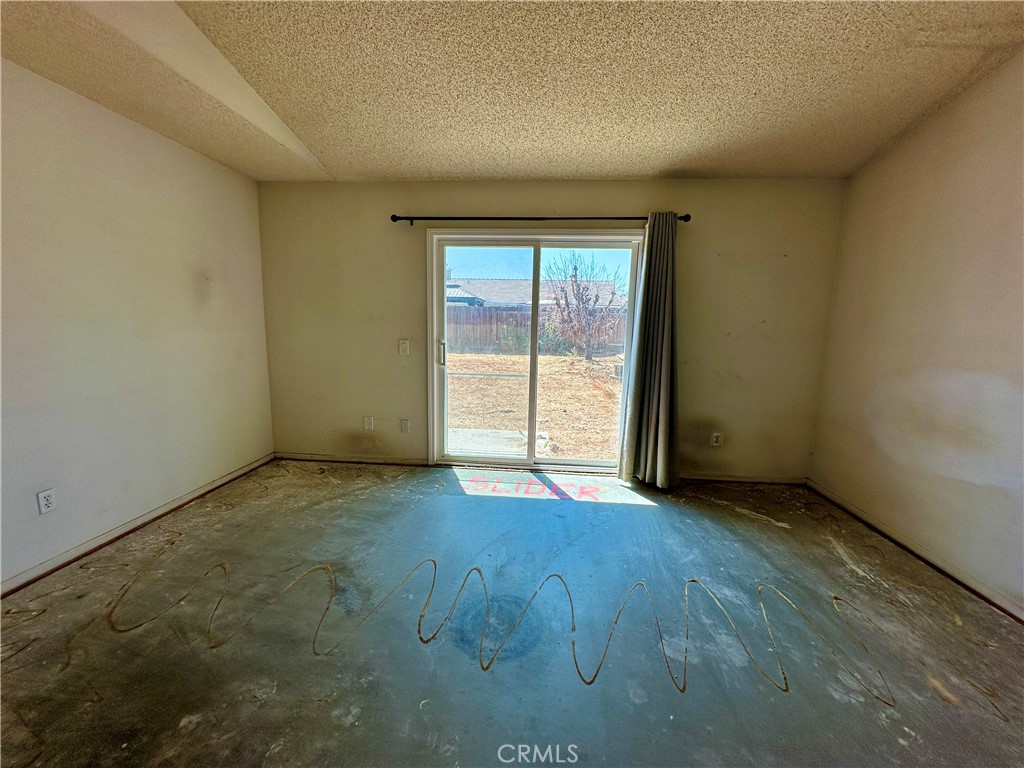 29784 Berea Road Menifee, CA 92584 - Photo 12 of 24 an empty room with wooden floor and sliding door