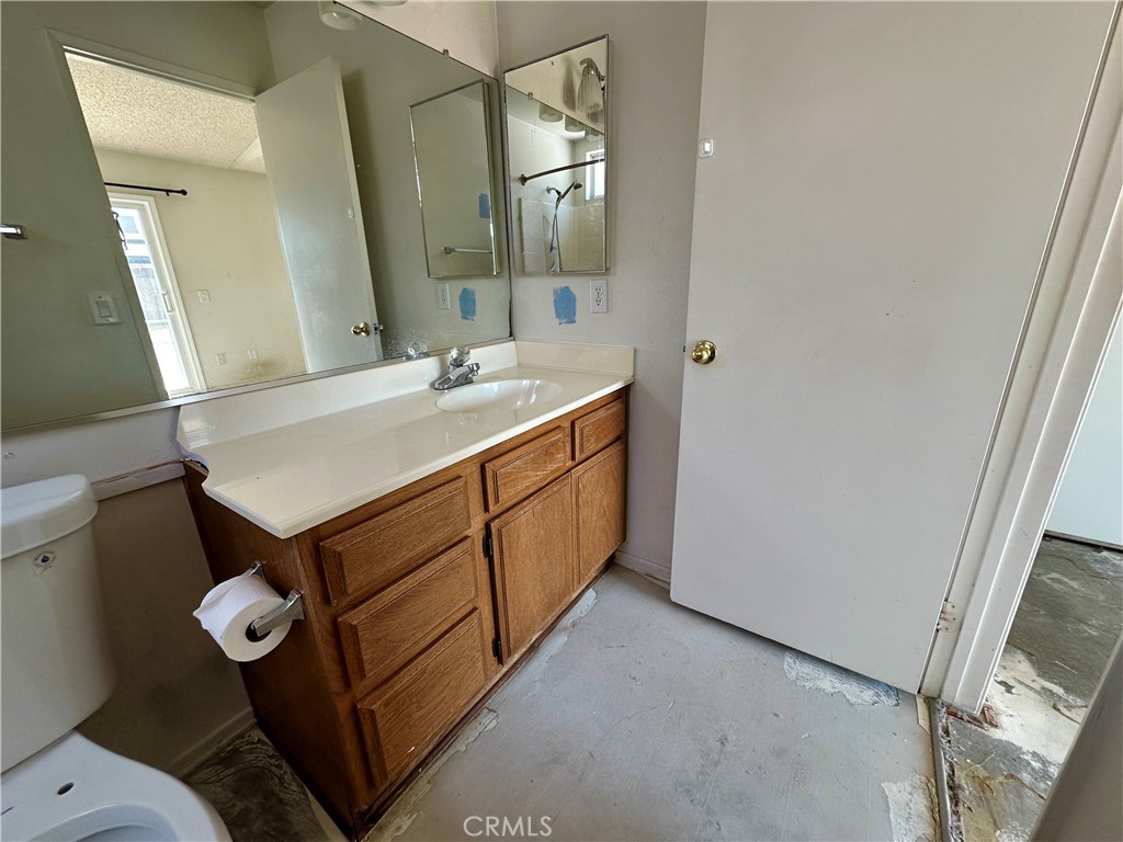 29784 Berea Road Menifee, CA 92584 - Photo 13 of 24 a bathroom with a sink a toilet and mirror