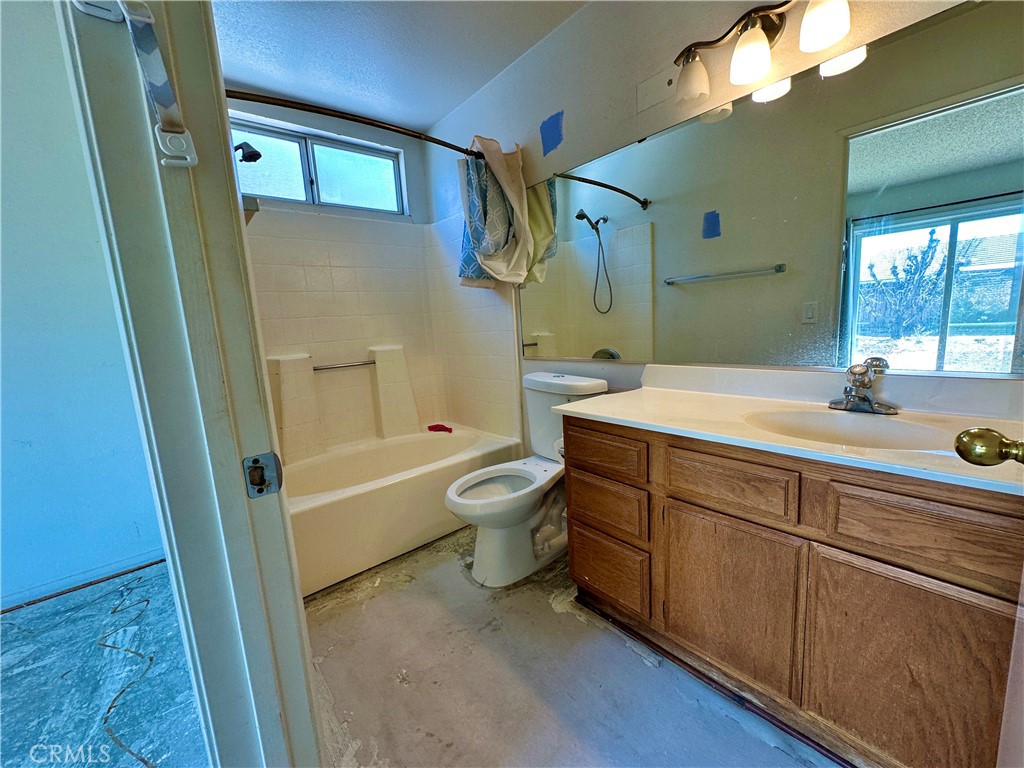 29784 Berea Road Menifee, CA 92584 - Photo 14 of 24 a bathroom with a sink a toilet and a bathtub