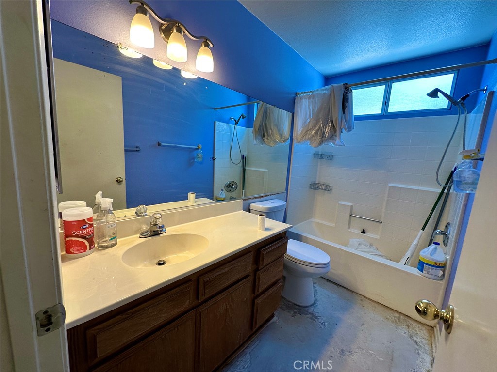 29784 Berea Road Menifee, CA 92584 - Photo 16 of 24 a bathroom with a sink a toilet and shower