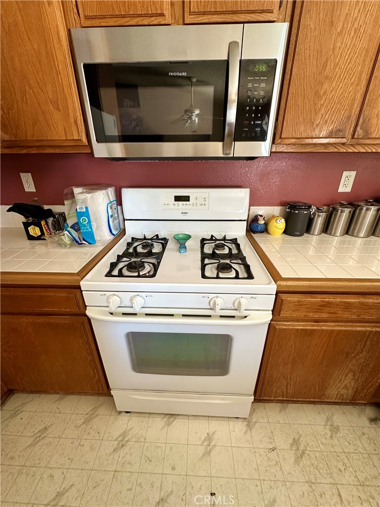 29784 Berea Road Menifee, CA 92584 - Photo 3 of 24 a kitchen with a stove and a microwave