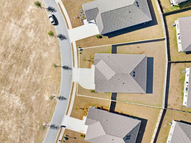 an aerial view of a house with a swimming pool patio and outdoor seating