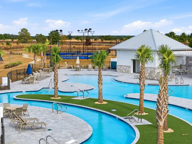 a view of a swimming pool with lounge chairs