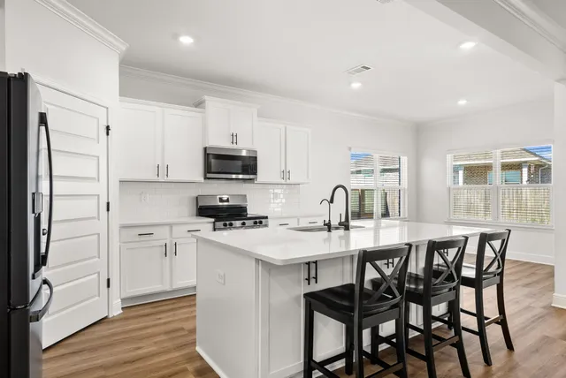 a view of kitchen with cabinets and wooden floor