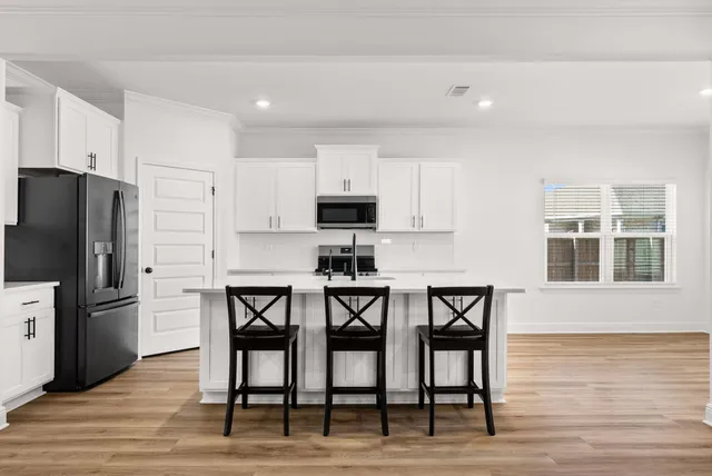 a view of an empty room and wooden floor