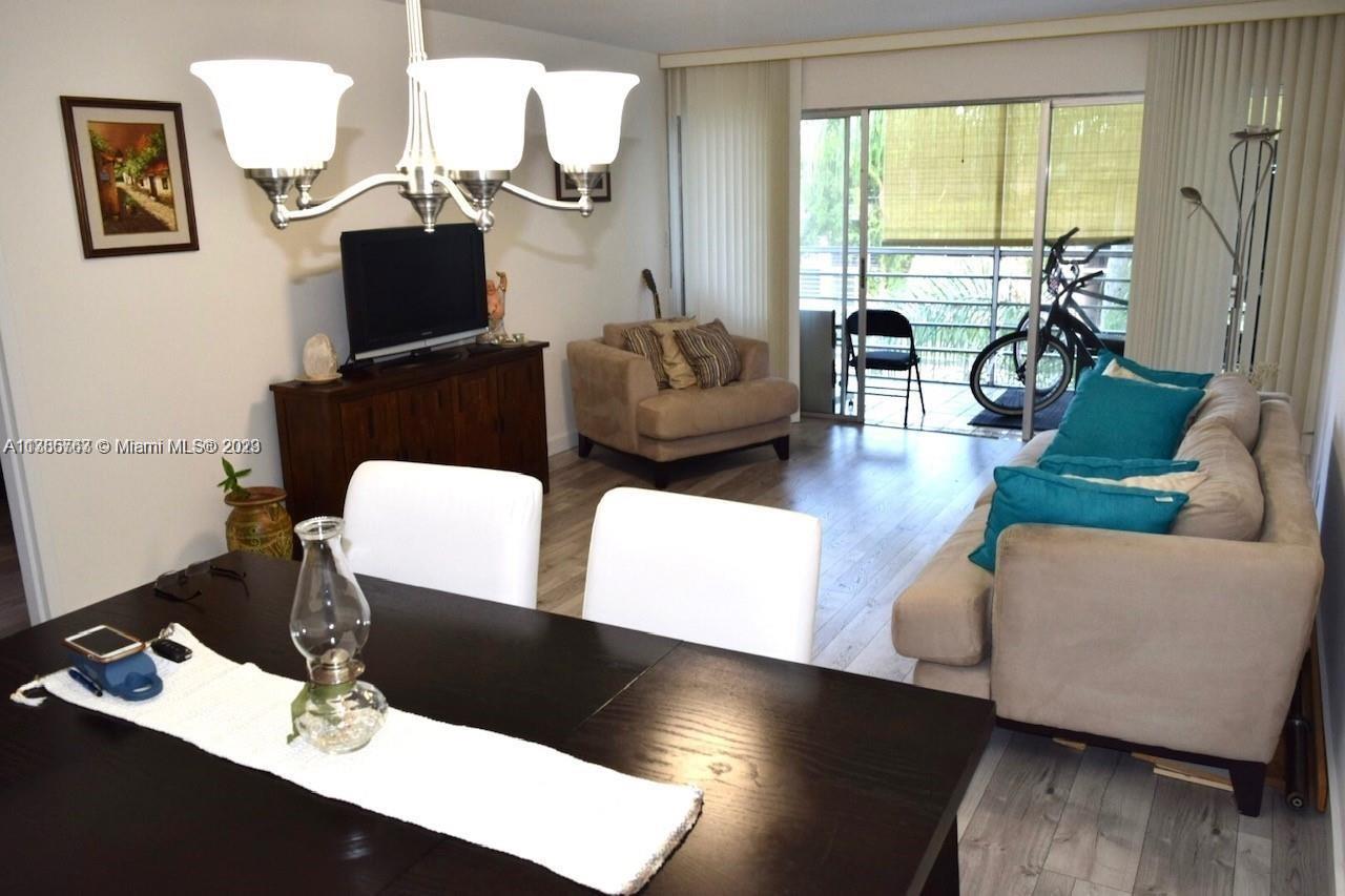 8330 Sands Point Boulevard, Unit N306 Tamarac, FL 33321 - Photo 11 of 20 a living room with furniture and a flat screen tv