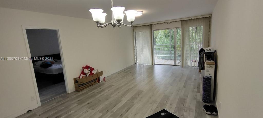 8330 Sands Point Boulevard, Unit N306 Tamarac, FL 33321 - Photo 12 of 20 a view of a room with wooden floor fan and windows