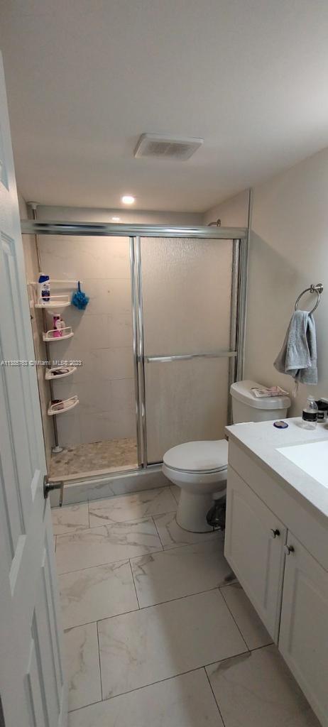 8330 Sands Point Boulevard, Unit N306 Tamarac, FL 33321 - Photo 13 of 20 a bathroom with a granite countertop sink toilet and shower