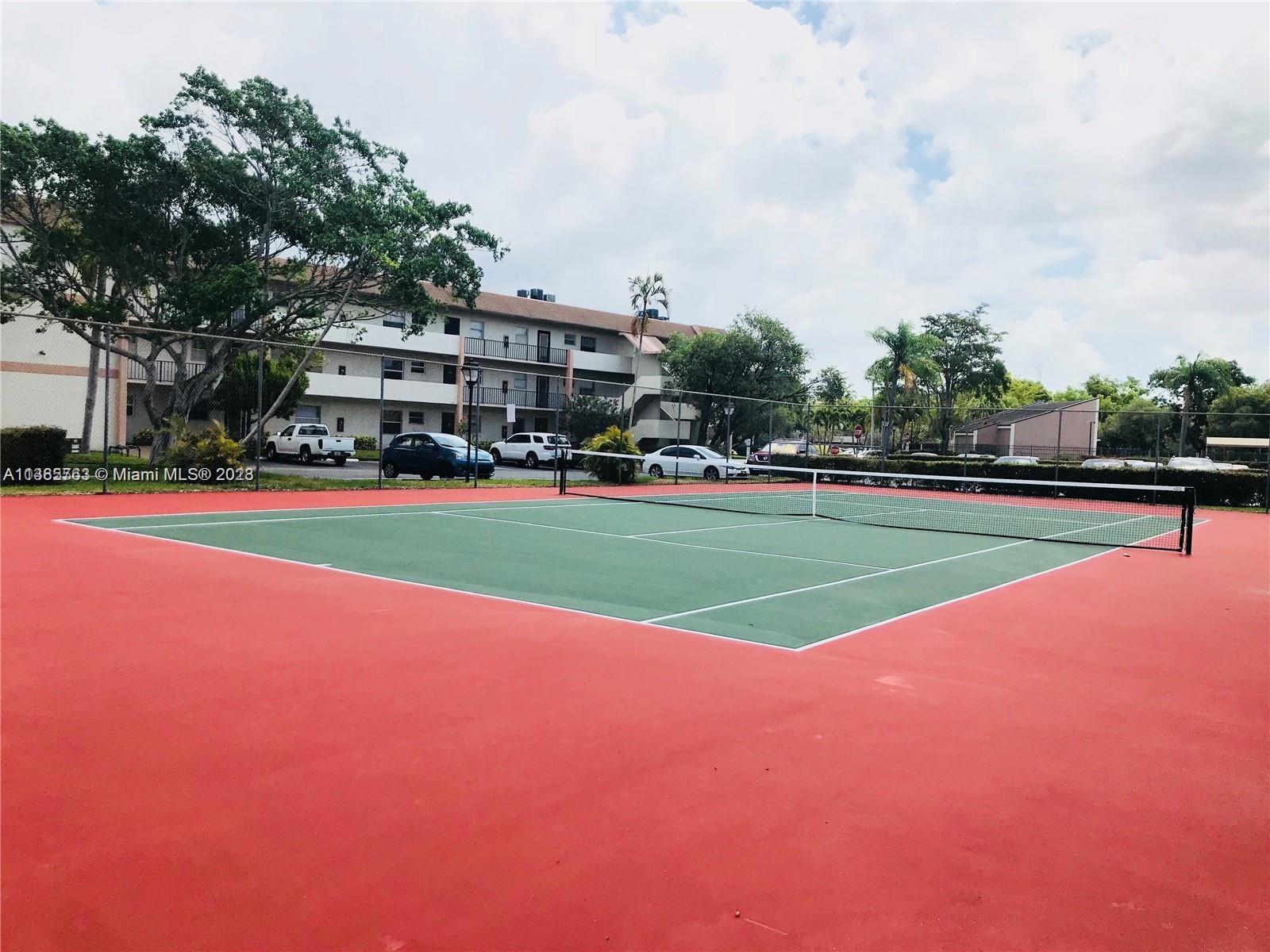 8330 Sands Point Boulevard, Unit N306 Tamarac, FL 33321 - Photo 20 of 20 a view of outdoor space with swimming pool and green space