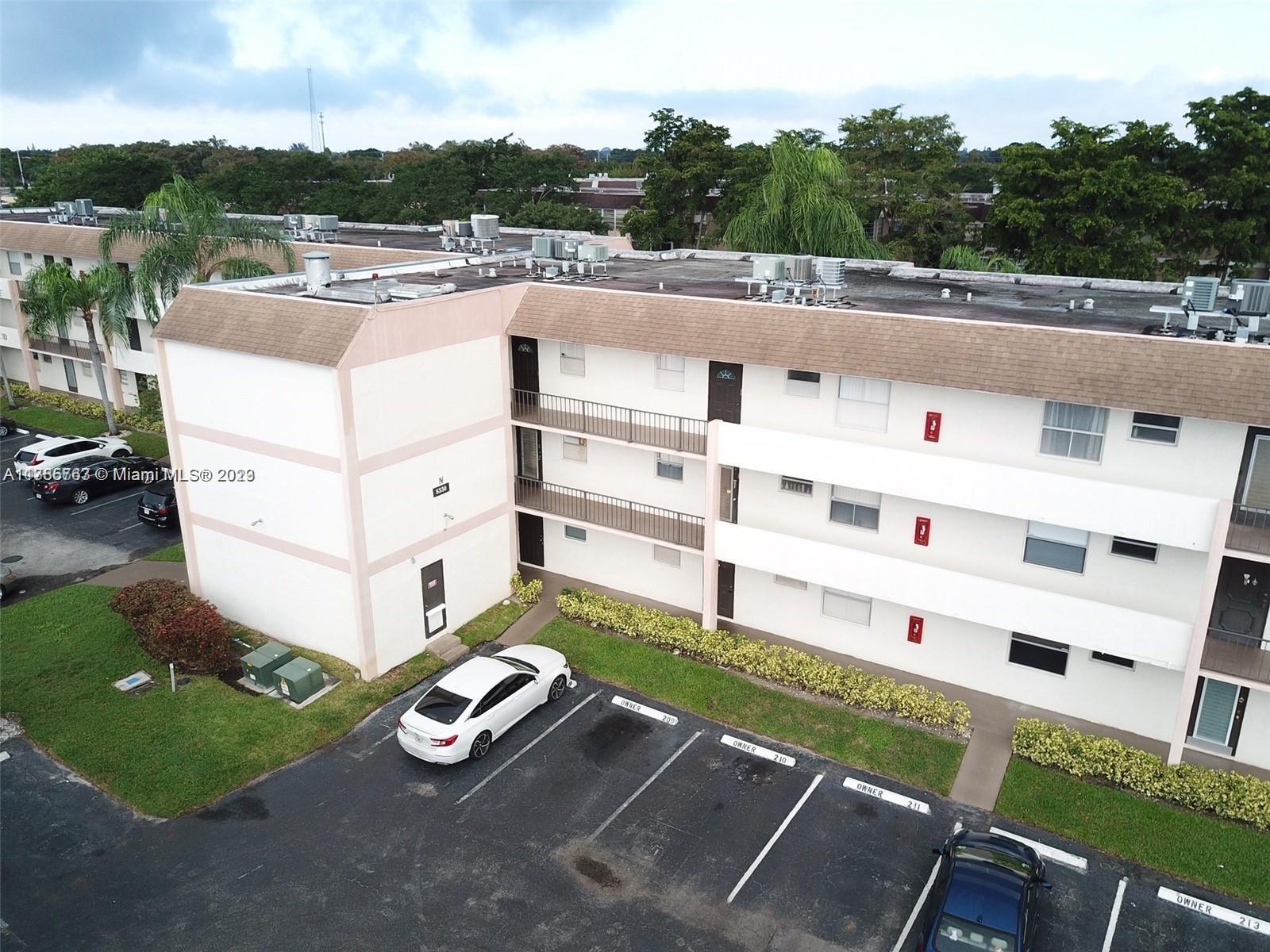 8330 Sands Point Boulevard, Unit N306 Tamarac, FL 33321 - Photo 2 of 20 a view of a white house with a yard