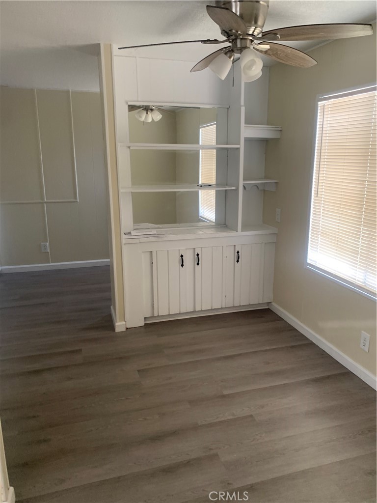2865 West Rialto Avenue, Unit 2 Rialto, CA 92376 - Photo 6 of 19 a view of an empty room with a window and wooden floor