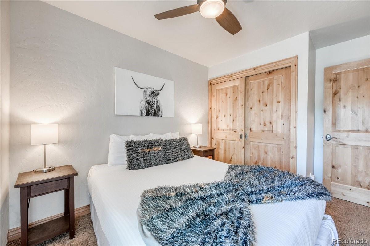 200 North Ridge Street, Unit R1 Breckenridge, CO 80424 - Photo 3 of 27 a bedroom with a bed and a chandelier