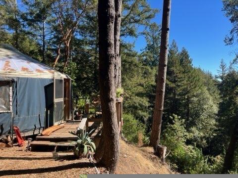 7227 Fern Flat Road Aptos, CA 95003 - Photo 3 of 8 a view of a house with backyard sitting area and garden