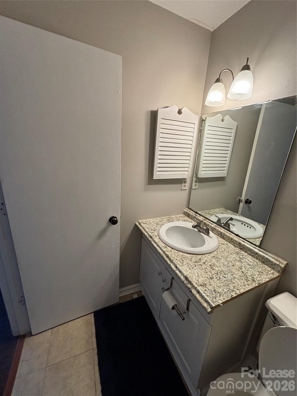 11040 Harrowfield Road Charlotte, NC 28226 - Photo 10 of 14 a bathroom with a granite countertop sink and a mirror