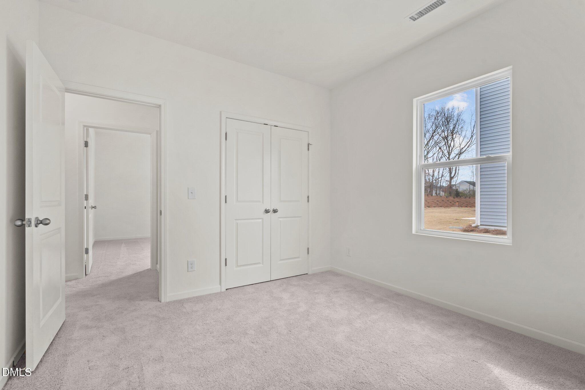 305 Cherubic Way Rolesville, NC 27571 - Photo 21 of 29 a view of an empty room with windows and closet