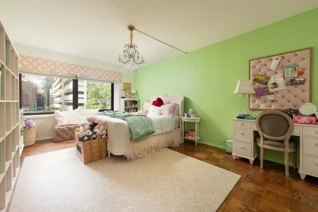a bedroom with a bed and a chandelier