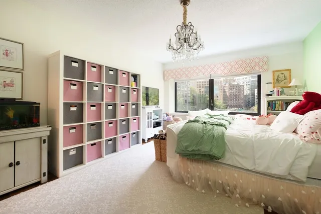 a bedroom with a large bed and a tv