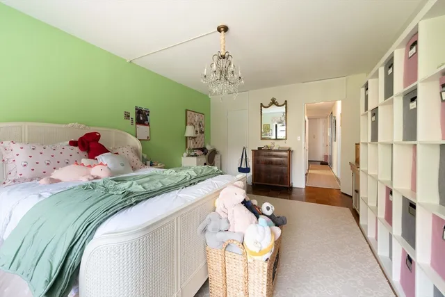 a bedroom with a bed and a chandelier