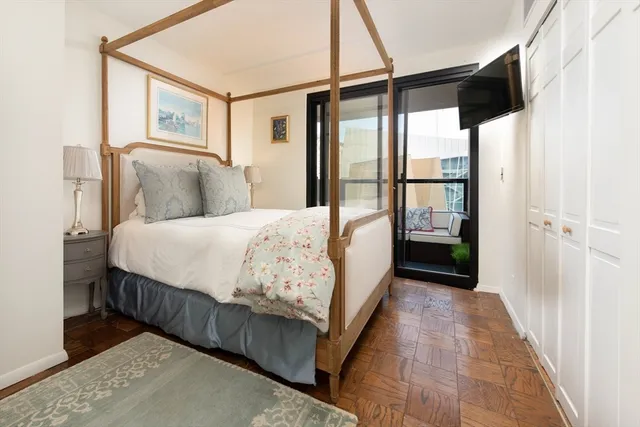 a bedroom with a large bed and a large window