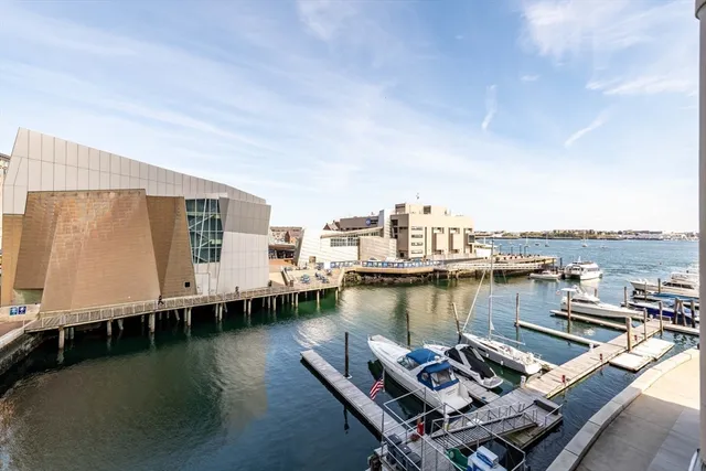 a view of a ocean with boats and trees in the background