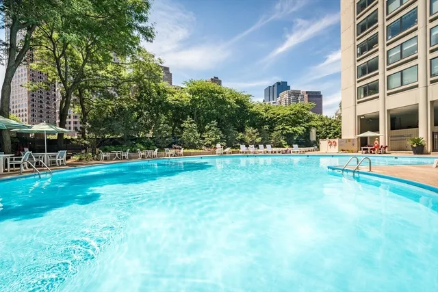 a view of yard with swimming pool and trees