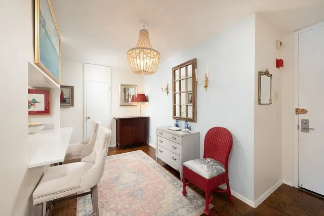 a view of living room filled with furniture and a chandelier