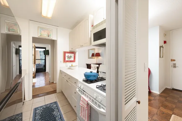a kitchen with a refrigerator and cabinets