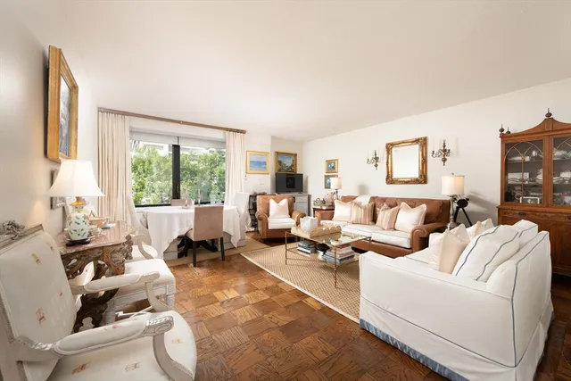 a living room with furniture large window and a table