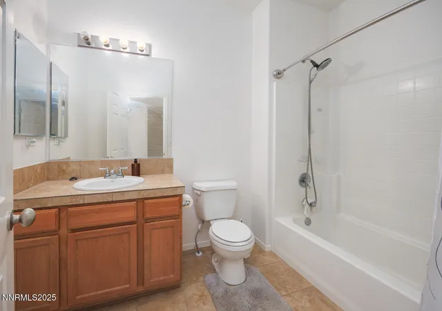 a bathroom with a sink toilet vanity and shower