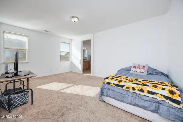 a bedroom with a bed and dresser