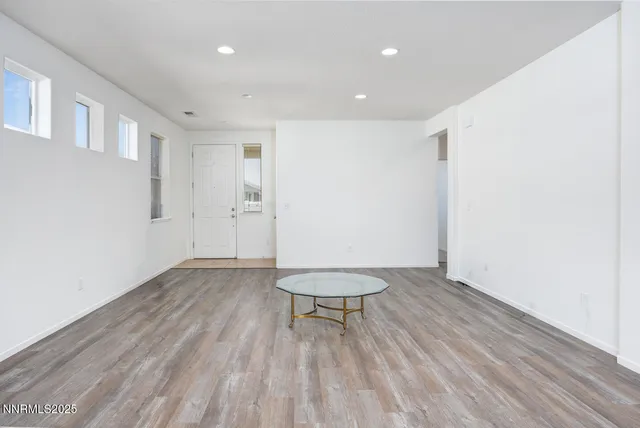 a view of a room with wooden floor and a bench