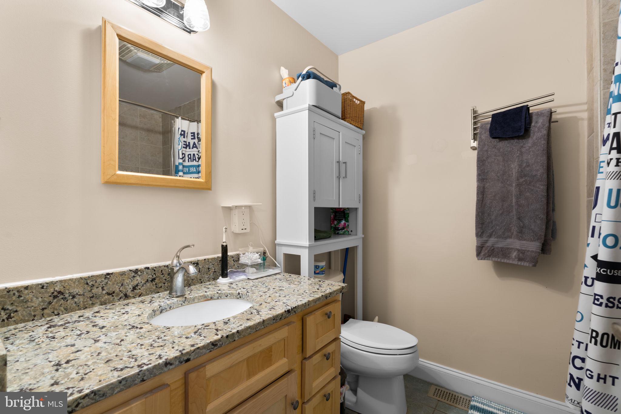 791 Central Avenue East Edgewater, MD 21037 - Photo 26 of 54 a bathroom with a granite countertop sink and a toilet