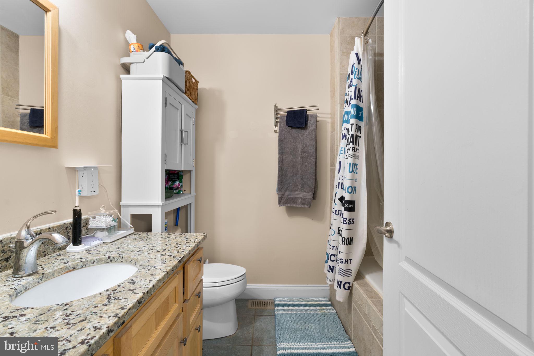791 Central Avenue East Edgewater, MD 21037 - Photo 27 of 54 a bathroom with a granite countertop sink and a mirror