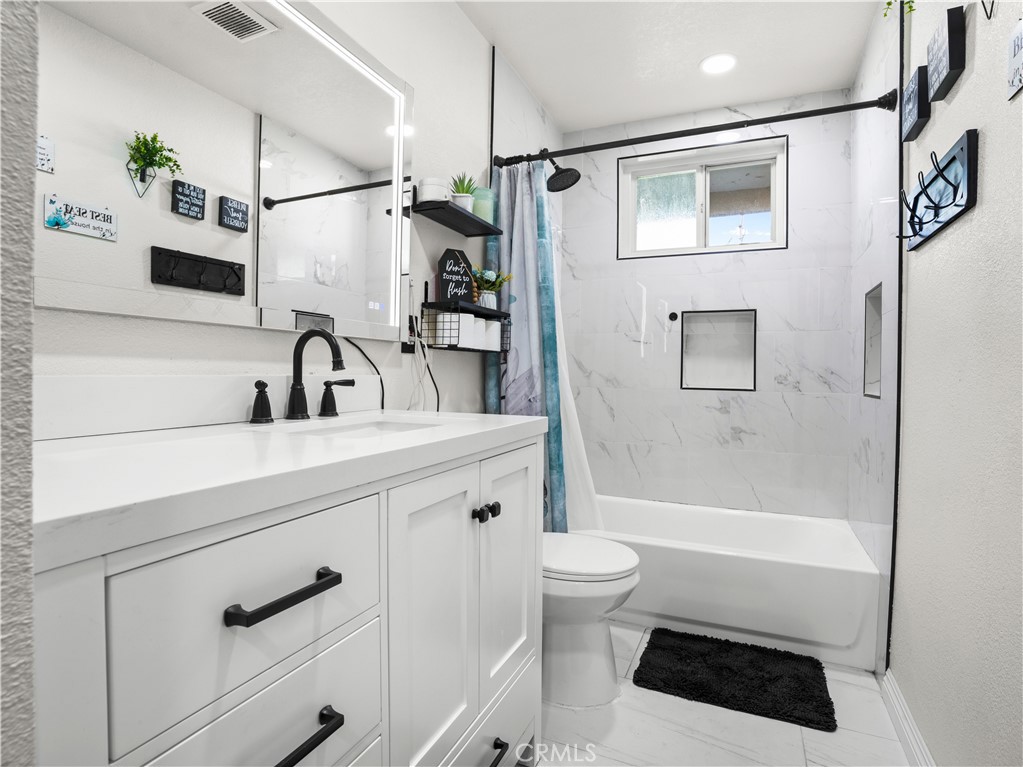 1455 North Alice Avenue Rialto, CA 92376 - Photo 15 of 23 a bathroom with a sink a toilet and shower