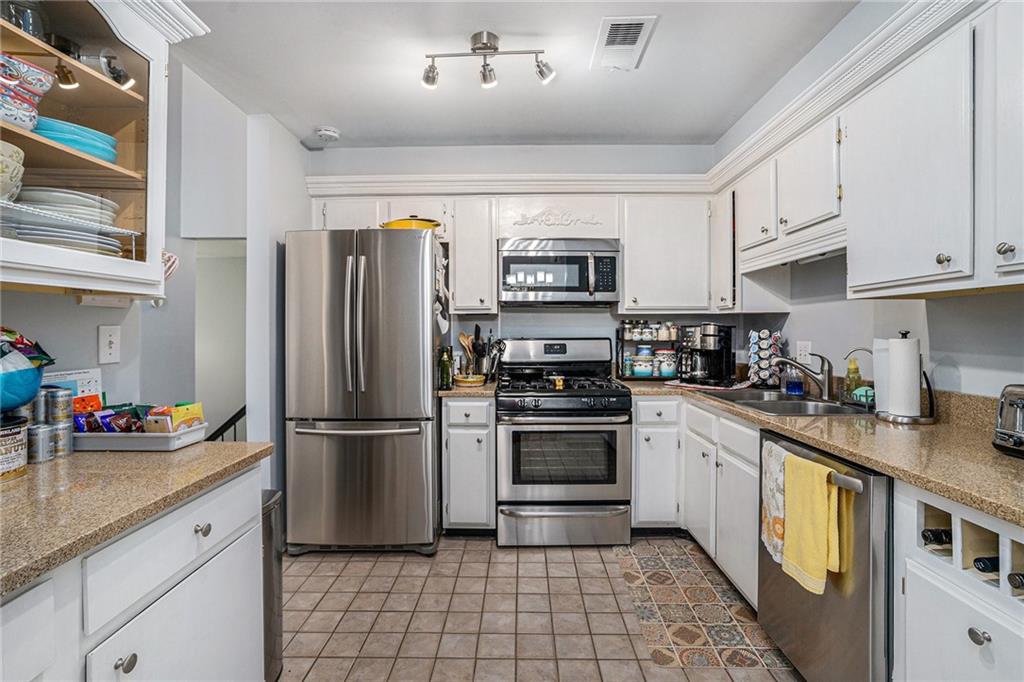 3813 Paces Ferry West Atlanta, GA 30339 - Photo 2 of 22 a kitchen with stainless steel appliances granite countertop a refrigerator stove microwave and sink
