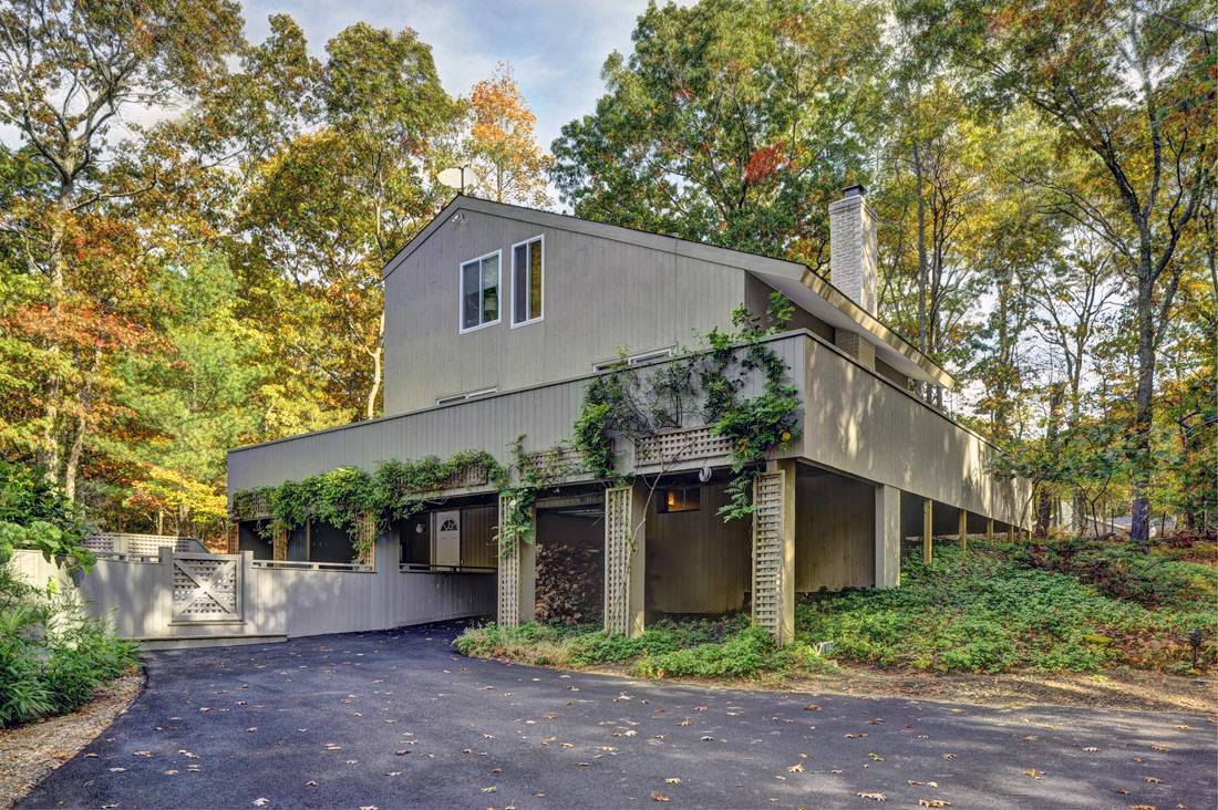 a front view of house with yard and trees