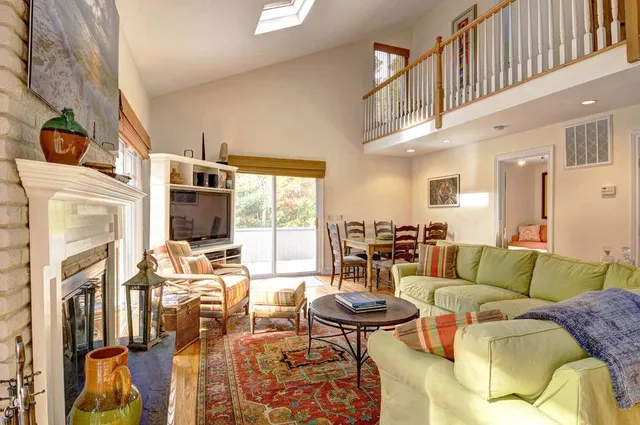 a living room with furniture fireplace and a flat screen tv
