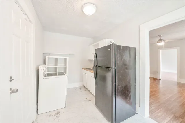 a kitchen with a refrigerator and a sink