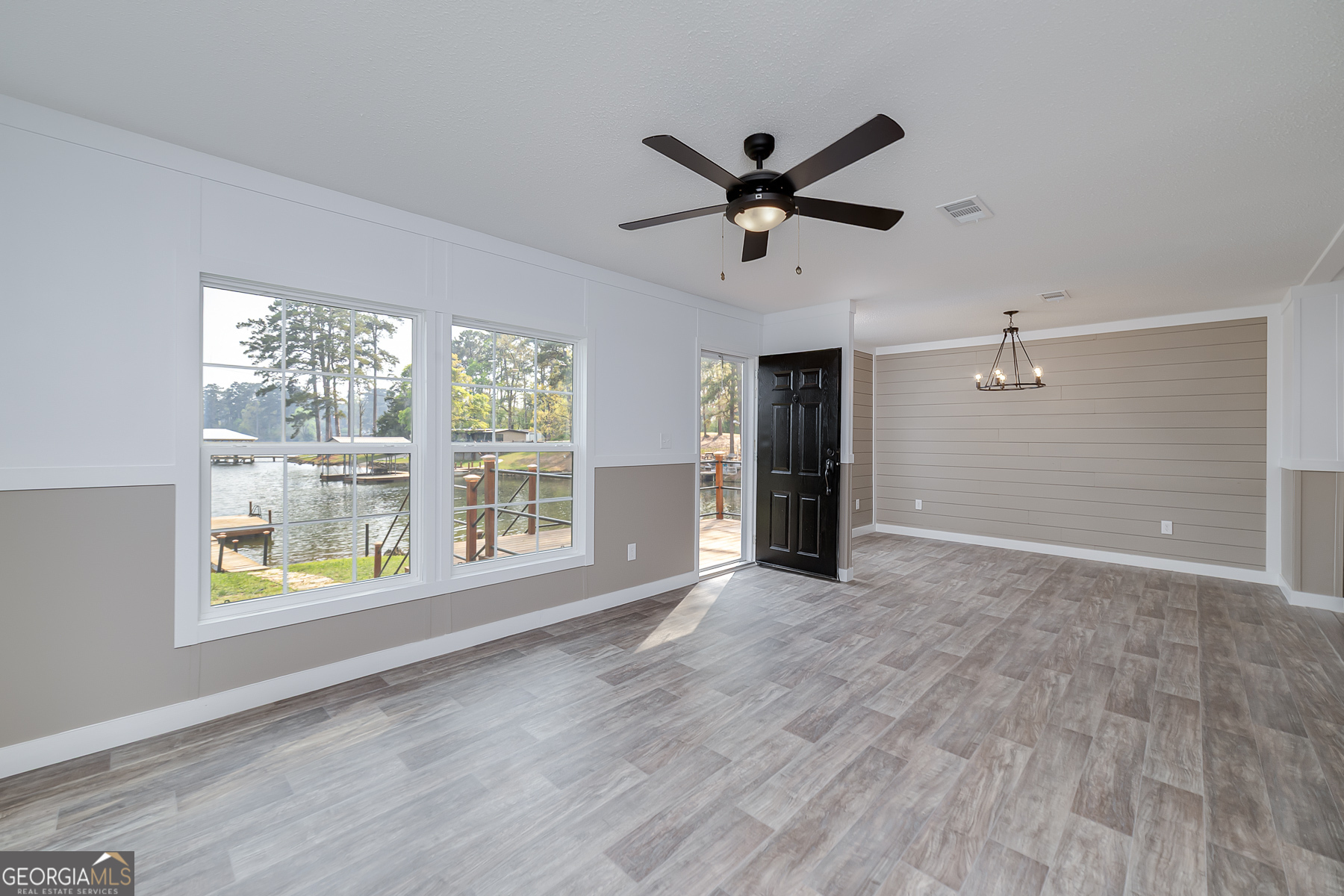 595 Barnetts Bridge Road Jackson, GA 30233 - Photo 14 of 47 a view of an empty room with a window and wooden floor