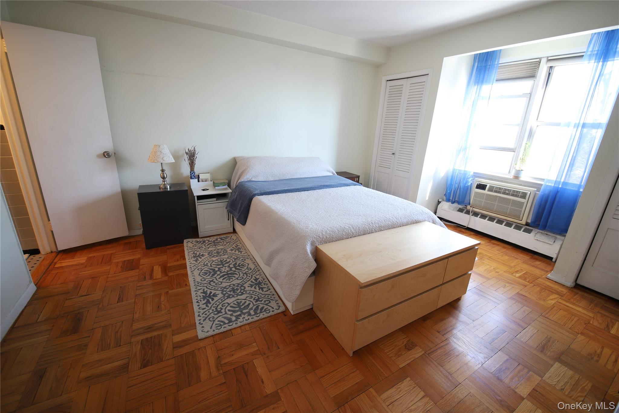 5500 Fieldston Road, Unit 3DD Bronx, NY 10471 - Photo 11 of 24 a bedroom with a bed lamp and a large window