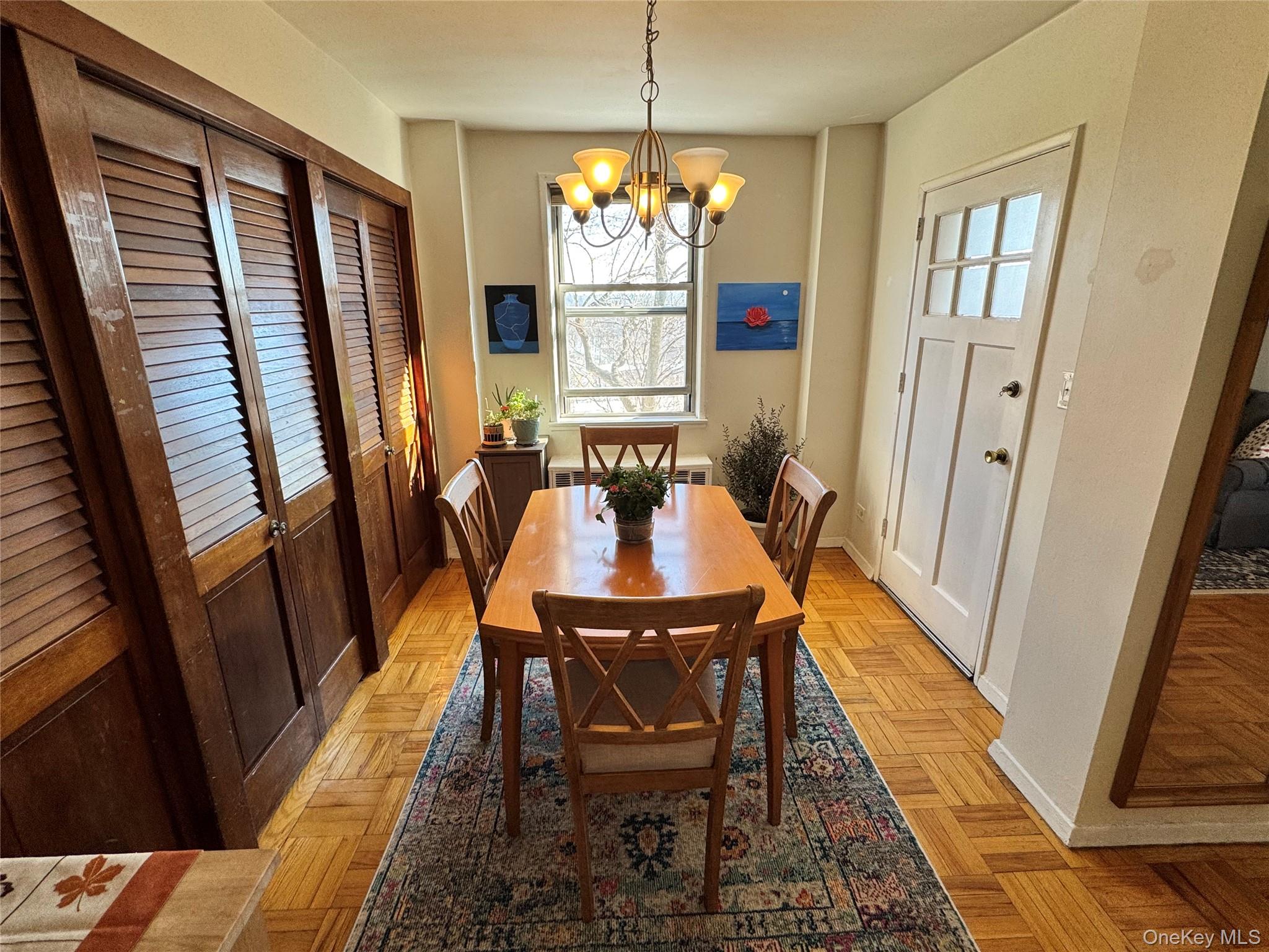 5500 Fieldston Road, Unit 3DD Bronx, NY 10471 - Photo 4 of 24 a dining room with furniture a rug and wooden floor