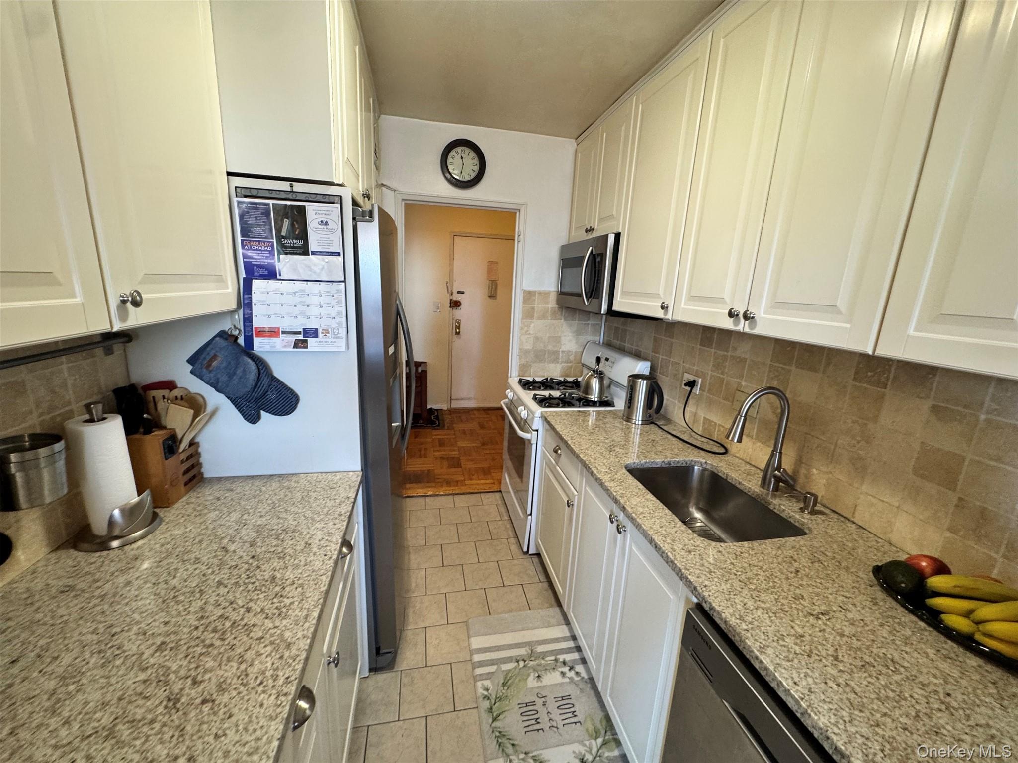 5500 Fieldston Road, Unit 3DD Bronx, NY 10471 - Photo 6 of 24 a kitchen with stainless steel appliances granite countertop a sink stove and refrigerator