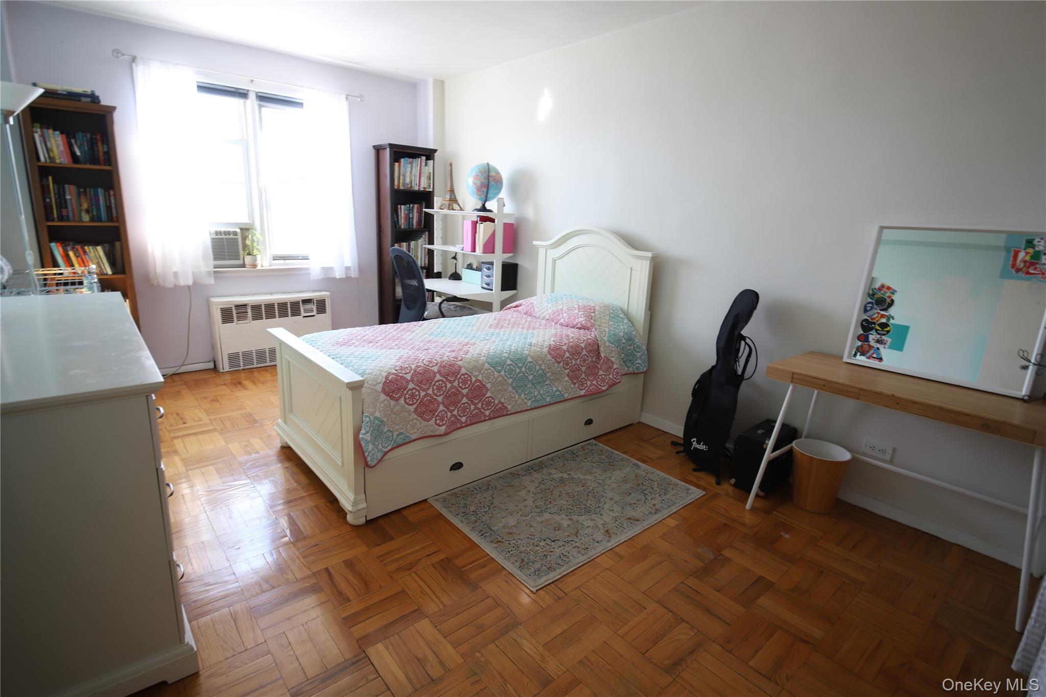 5500 Fieldston Road, Unit 3DD Bronx, NY 10471 - Photo 10 of 24 a bedroom with a bed a bookshelf a desk and chair