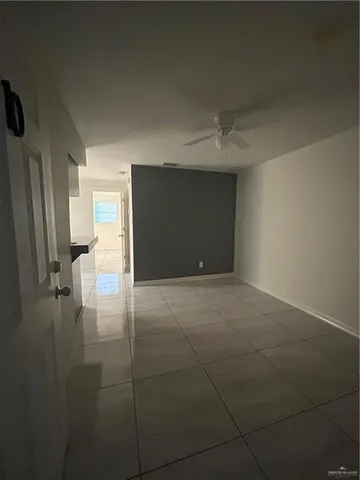 a view of an empty room and a window