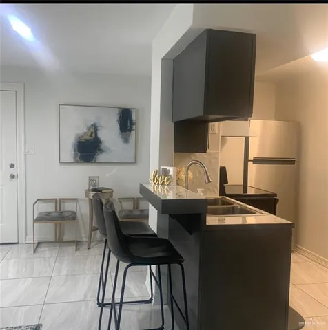 a kitchen with a sink cabinets and dining table