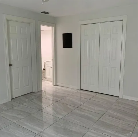 a view of a livingroom with an empty space and a window