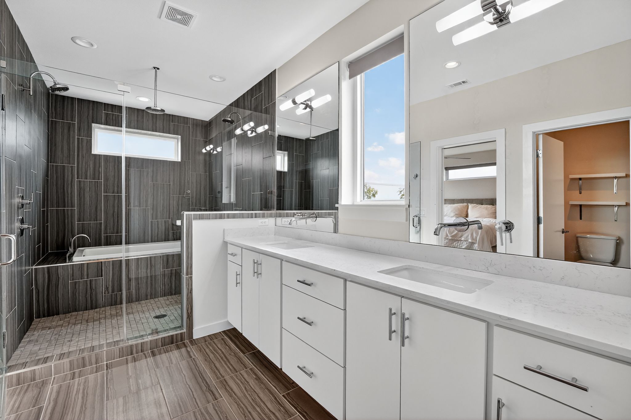 2301 Bluebonnet Lane, Unit 5 Austin, TX 78704 - Photo 18 of 26 Full bathroom featuring double vanity, a shower stall, plenty of natural light, and recessed lighting