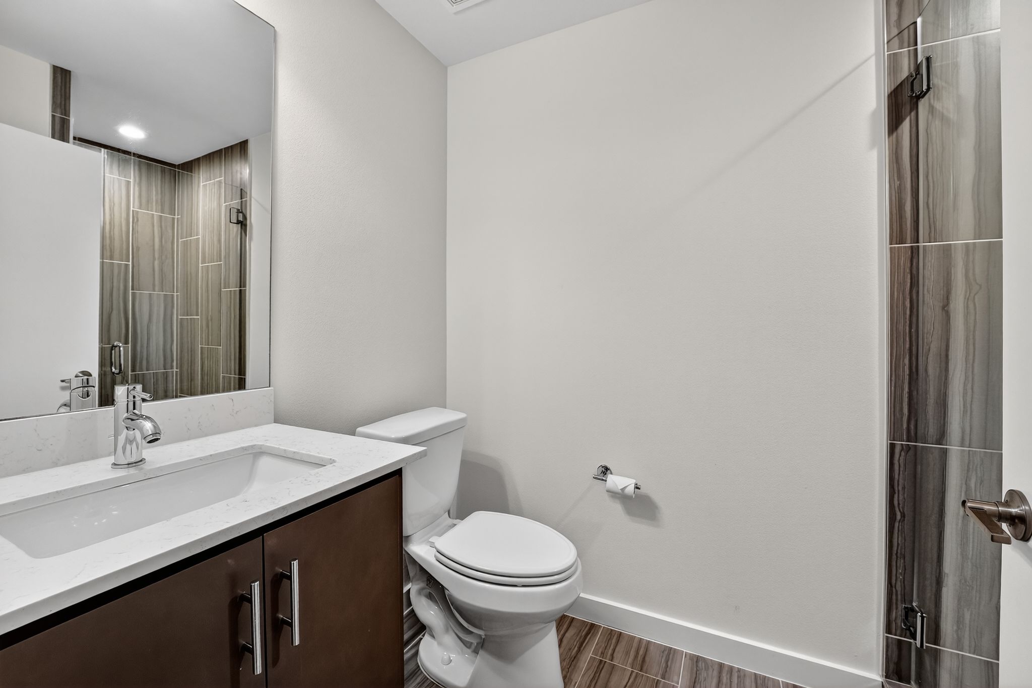 2301 Bluebonnet Lane, Unit 5 Austin, TX 78704 - Photo 8 of 26 Full bathroom featuring vanity, wood tiled floors, and a shower