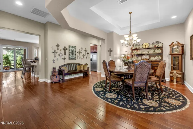 a view of a dining room with furniture and chandelier